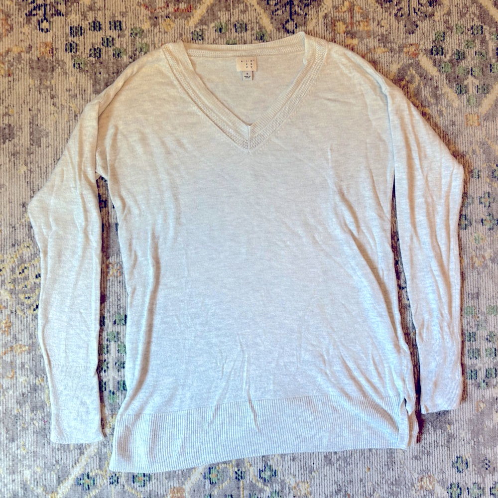 A New Day light gray v-neck sweater.